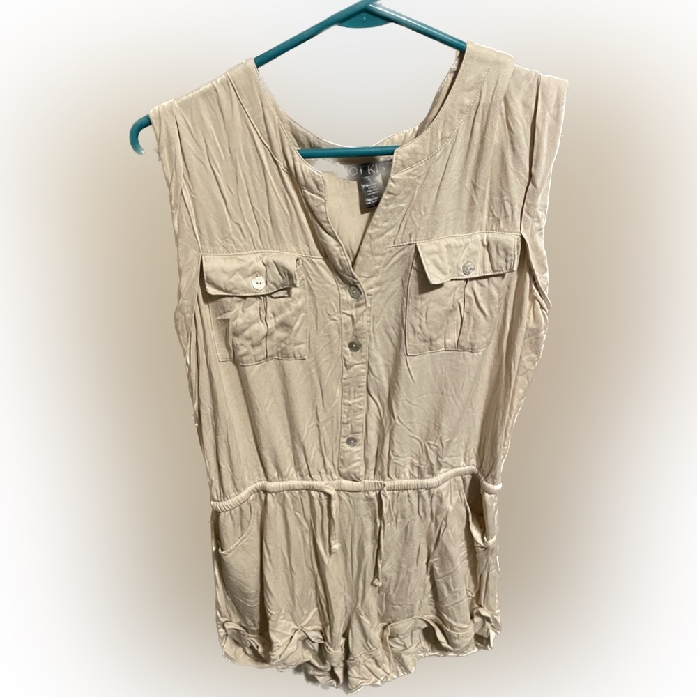 Cream color, romper, short with button down and tight on in the waist.